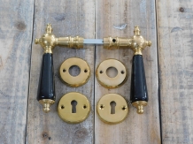 Set of door handles with rosettes - polished brass - with black ceramic handles