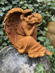 Beautiful seated angel, full of detail, cast iron rest