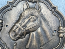 Wall coat rack with horse head image, cast iron, 2 hooks.