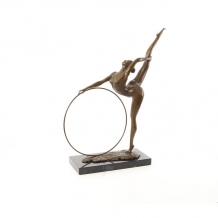 A bronze statue/sculpture of a hula hoop dancer