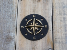 A cast iron plate as a compass for example on the wall