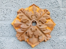 Wall anchor, cast iron, rust brown, leaf shape.