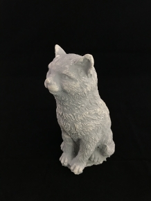 A beautiful sitting cat, made of stone, beautiful in detail