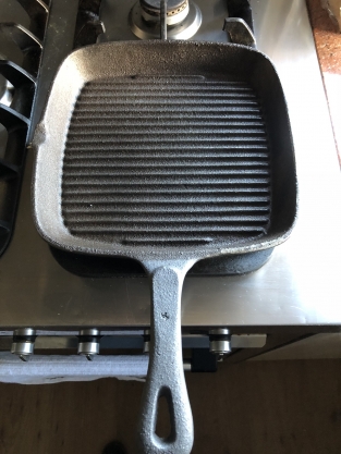 Heavy cast-iron grill pan, old-fashioned top quality.