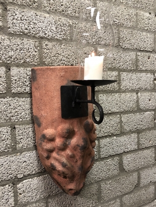 Wind light of roof tile with mythical image, with candlestick and glass flask.