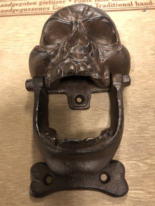 Cast iron brown skull as door knocker.