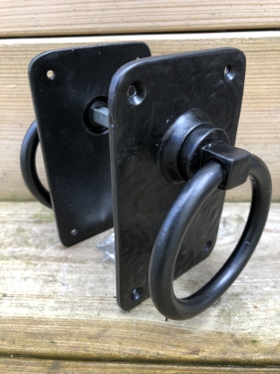 Pair off rustic large black rings as door closers/gate closers, beautifully nostalgic.