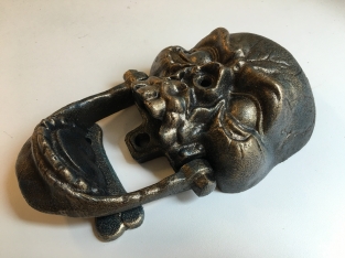 Cast iron bronze skull as door knocker.