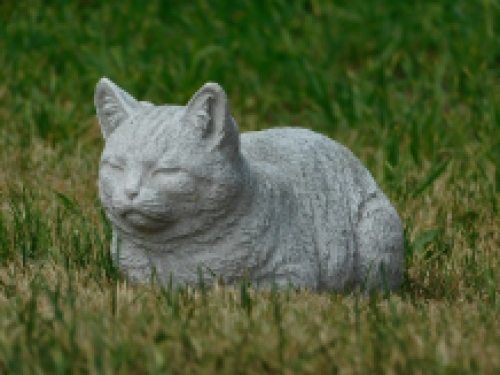 Statue of a lying cat - made entirely of stone - garden statue