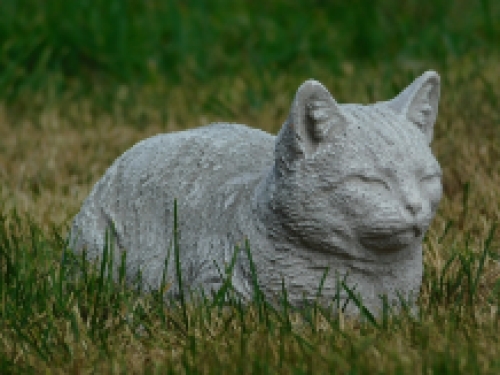 Statue of a lying cat - made entirely of stone - garden statue