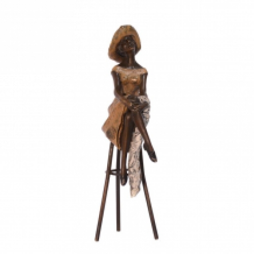 A bronze statue/sculpture of a woman sitting on a stool