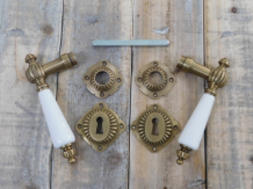 Set of door handles with rosettes - patinated brass 