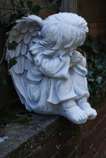 Beautiful sitting angel, full of detail, full of stone.