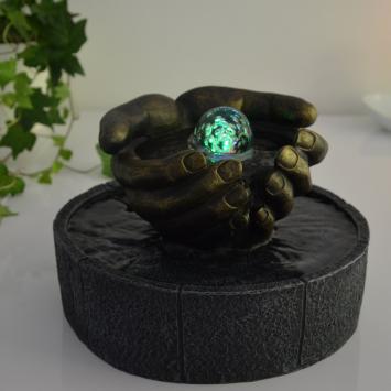 Indoor fountain, hands as bowl, illuminated water ornament