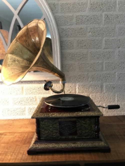 Graceful nostalgic gramophone, record player made of brass and wood