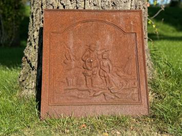 Antique hearth plate with old scene, vintage cast iron, rustic