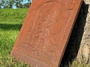 Antique hearth plate with old scene, vintage cast iron, rustic