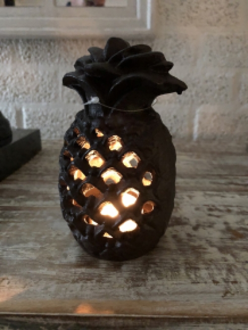 Cast iron lantern in the shape of a pineapple, atmospheric lighting.