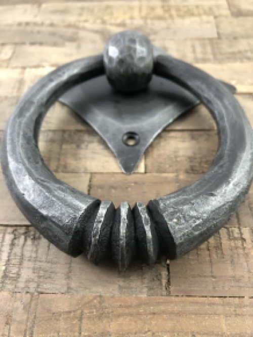 Pull-ring - door knocker wrought iron for on the rustic wooden door, convent door, country house door.