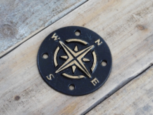 A cast iron plate as a compass for example on the wall