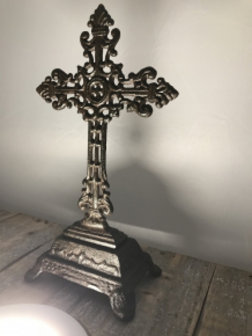 A cross on a stand made of cast iron