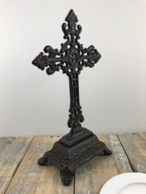 A cross on a stand made of cast iron