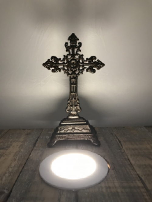 A cross on a stand made of cast iron