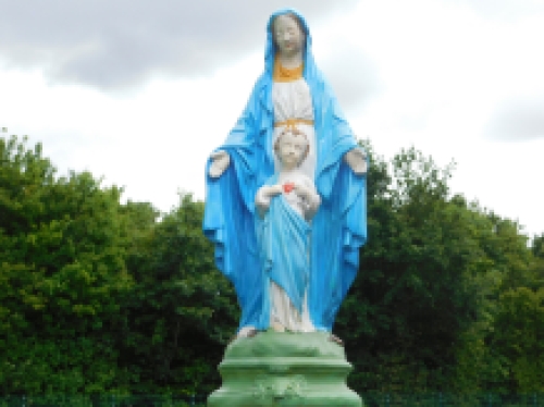 Mary with Jesus' sacred heart, full of stone church statue.