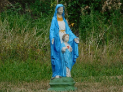 Mary with Jesus' sacred heart, full of stone church statue.