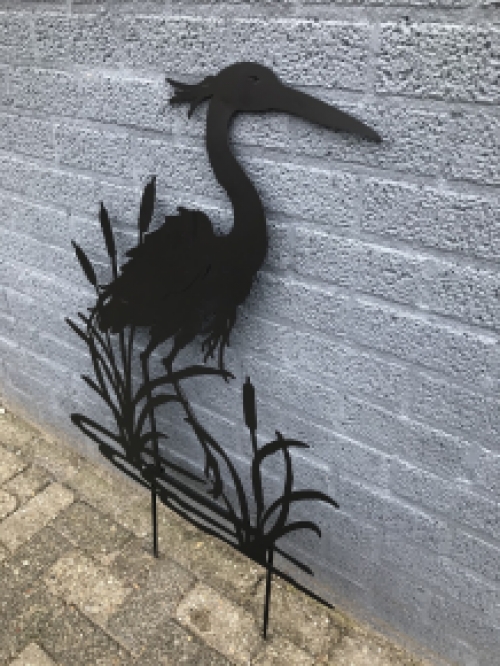 A silhouette of a heron, matte black