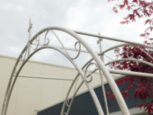 Large white rose arch as a romantic garden decoration, beautiful to see.