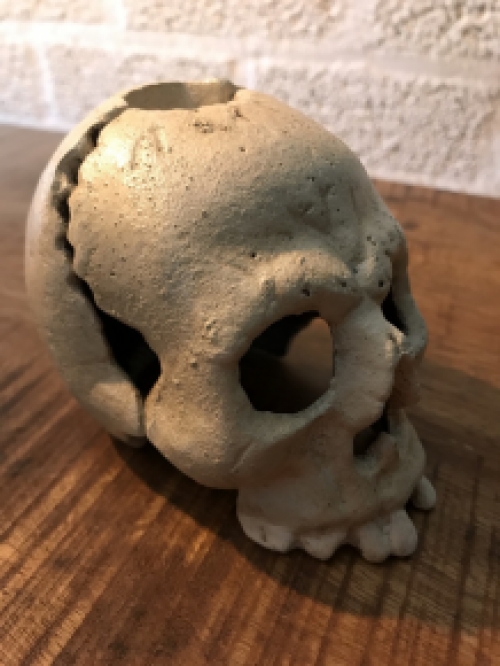 Skull as a candlestick, candle holder as a skull