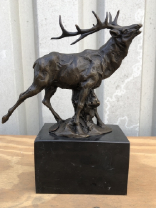 A bronze statue/sculpture of a deer