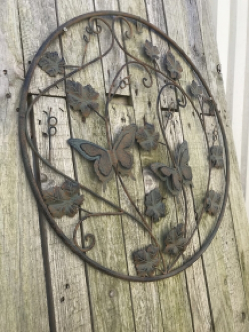 A metal wall ornament with leaves and butterflies, very decorative!