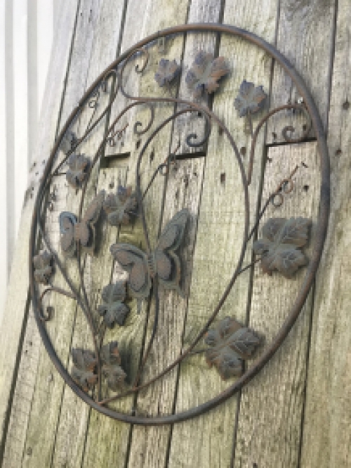 A metal wall ornament with leaves and butterflies, very decorative!