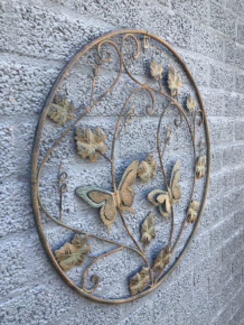 A metal wall ornament with leaves and butterflies, very decorative!